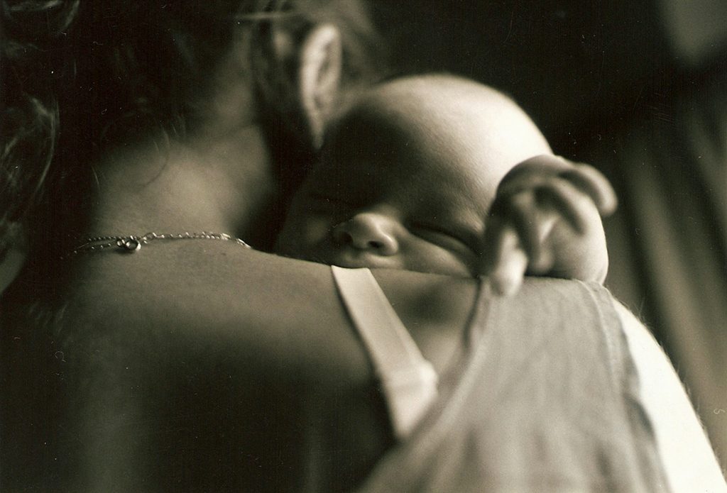 “Mother holding her baby, illustrating nurturing postpartum support